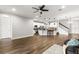Open-concept living room with modern flooring and kitchen featuring an island with barstool seating at 1003 Starboard Ct, Oldsmar, FL 34677