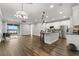 Open-concept living space featuring a modern kitchen, wood floors, and access to a screened patio at 1003 Starboard Ct, Oldsmar, FL 34677