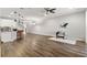 Open-concept living room and modern kitchen with an island, dark wood floors, and stylish decor at 1003 Starboard Ct, Oldsmar, FL 34677