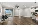 Open-concept living area with hardwood floors, ceiling fan, and balcony access, adjoining modern kitchen at 1003 Starboard Ct, Oldsmar, FL 34677