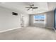 Bright and airy main bedroom with tray ceiling, carpeted floors, and a door to the bathroom at 1003 Starboard Ct, Oldsmar, FL 34677