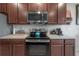 Modern kitchen with stainless steel appliances and granite countertop at 10792 Hawks Landing Dr, Land O Lakes, FL 34638