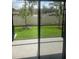 View of backyard, highlighting the patio, green lawn, and privacy fence at 11851 Davis Dr, Largo, FL 33774