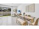 Open concept dining area with wooden table and bench at 11851 Davis Dr, Largo, FL 33774