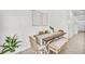 Modern dining area with wooden table and woven chairs at 11851 Davis Dr, Largo, FL 33774
