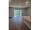 Spacious living room featuring hardwood floors and large sliding glass doors to backyard at 11851 Davis Dr, Largo, FL 33774