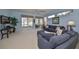 Living room with blue walls, sectional sofa, and access to patio at 1237 Huntington Greens Dr, Sun City Center, FL 33573