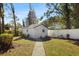 Landscaped backyard with shed and walkway at 13208 Lake Magdalene Blvd, Tampa, FL 33618