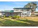 Backyard view of house with screened patio and lush lawn at 13208 Lake Magdalene Blvd, Tampa, FL 33618