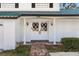 White double front doors with brick walkway at 13208 Lake Magdalene Blvd, Tampa, FL 33618