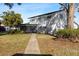 Back exterior view showing house and screened porch at 13208 Lake Magdalene Blvd, Tampa, FL 33618