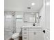 Modern bathroom with white vanity, marble shower, and black accents at 1741 25Th N Ave, St Petersburg, FL 33713