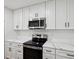 Stainless steel appliances and white cabinets in kitchen at 1741 25Th N Ave, St Petersburg, FL 33713