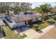 Aerial view of a single-Gathering home with a spacious yard and surrounding neighborhood at 1809 Chinaberry Dr, Oldsmar, FL 34677