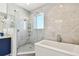 Elegant bathroom featuring a glass shower, soaking tub, and marble accents at 20001 Gulf Blvd # 501, Indian Shores, FL 33785