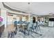 Bright dining room features a modern chandelier, sleek table with seating for eight, and a view of the updated kitchen at 20001 Gulf Blvd # 501, Indian Shores, FL 33785