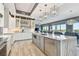 Modern kitchen with gray island, stainless appliances, and open to living area at 20001 Gulf Blvd # 501, Indian Shores, FL 33785