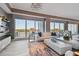 Elegant living room with floor-to-ceiling windows offering stunning water views and sophisticated decor at 20001 Gulf Blvd # 501, Indian Shores, FL 33785