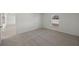 Bright bedroom with grey carpeting and access to another room at 20319 Blaine Ave, Port Charlotte, FL 33952