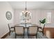 Bright dining room featuring a large table, chandelier, and hardwood floors at 2223 Rising Creek Court, Dunedin, FL 34698