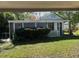 A charming green and white cottage with a screened porch at 2508 50Th N Ave, St Petersburg, FL 33714