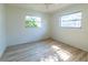 Bright bedroom with wood-look floors and two windows at 2869 Catherine Dr, Clearwater, FL 33759