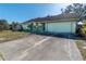 House exterior showcasing a driveway and mature trees at 2869 Catherine Dr, Clearwater, FL 33759