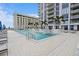 Modern pool with clear blue water, lounge chairs, and a stunning view of the harbor and ocean at 301 1St S St # 1005, St Petersburg, FL 33701