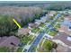 Aerial view of a house on a tree-lined street in a residential community at 3214 Glenridge Dr, Palm Harbor, FL 34685