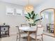 Elegant dining room features a round table, four chairs, and bar cart at 4521 Garofalo Rd, Wesley Chapel, FL 33543