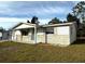 Side view of a ranch home showcasing its stone facade at 5027 Farley Dr, Holiday, FL 34690