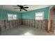 A teal-walled bedroom ready for renovation, showcasing exposed framing at 5641 1St Ne St, St Petersburg, FL 33703