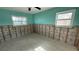 A teal-walled bedroom ready for renovation, showcasing exposed framing at 5641 1St Ne St, St Petersburg, FL 33703