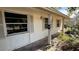 A beige house exterior with shutters and a small front porch at 5641 1St Ne St, St Petersburg, FL 33703