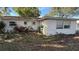 Rear exterior view of a single story home at 5641 1St Ne St, St Petersburg, FL 33703