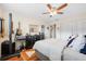 Bedroom with wood floors, ceiling fan and guitar at 5705 80Th N St # 214, St Petersburg, FL 33709