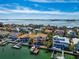Aerial view of waterfront home with boat dock and lush landscaping, showcasing coastal living at 6015 Kipps Colony E Dr, Gulfport, FL 33707