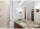 A bathroom featuring granite countertops, tile flooring, a mirror, and vanity lighting at 6015 Kipps Colony E Dr, Gulfport, FL 33707
