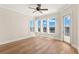 Bedroom featuring hardwood floors, plantation shutters, and an exterior door to a balcony at 6015 Kipps Colony E Dr, Gulfport, FL 33707