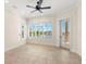 Bright bedroom with tile flooring, plantation shutters, and access to a private balcony at 6015 Kipps Colony E Dr, Gulfport, FL 33707