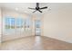 Bright bedroom features tile floors, plantation shutters, and private balcony access with water views at 6015 Kipps Colony E Dr, Gulfport, FL 33707