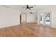 Bright bedroom with hardwood flooring and multiple windows with views and an exterior door to a balcony at 6015 Kipps Colony E Dr, Gulfport, FL 33707