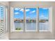 Bedroom view features white plantation shutters and scenic waterfront views at 6015 Kipps Colony E Dr, Gulfport, FL 33707