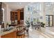 Bright dining area with large windows, chandelier, tile flooring, and adjacent bar for seamless entertaining and natural light at 6015 Kipps Colony E Dr, Gulfport, FL 33707