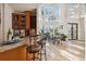 Bright dining area with large windows, chandelier, tile flooring, and adjacent bar for seamless entertaining and natural light at 6015 Kipps Colony E Dr, Gulfport, FL 33707
