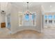 Bright dining area with large windows offering water views and a decorative chandelier at 6015 Kipps Colony E Dr, Gulfport, FL 33707