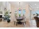 Cozy dining area with a chandelier, bright windows, and elegant furniture at 6015 Kipps Colony E Dr, Gulfport, FL 33707