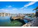 Waterfront view featuring a private boat dock on a sunny day with beautiful blue sky at 6015 Kipps Colony E Dr, Gulfport, FL 33707