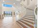 Bright entryway features a winding staircase, high ceilings, and a view of the waterfront at 6015 Kipps Colony E Dr, Gulfport, FL 33707