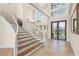 Elegant entryway with stained glass windows, a chandelier, and a winding staircase for a grand entrance at 6015 Kipps Colony E Dr, Gulfport, FL 33707